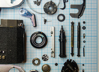 parts old retro film SLR camera on graph paper
