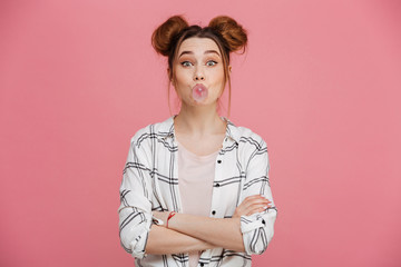 Portrait of a cute young girl blowing gum bubble