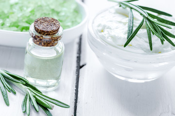 organic cosmetics with rosemary extract on wooden table backgrou