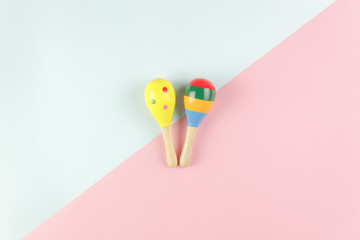 Table top view kids toys for develop background concept.Flat lay objects the colorful wooden ball percussion musical instruments on modern duo paper blue & pink at office desk.Design pastel tone.