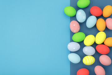Table top view shot of decoration Happy Easter holiday background concept.Flat lay essential objects with bunny eggs on modern blue paper at office desk. Negative space for creative design add text.