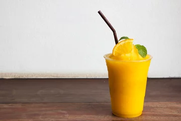 Papier Peint photo autocollant Jus Orange juice blended in plastic cup. Freshness beverage. Tropical fruit.