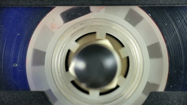 Old Audio cassette reel playing. Close-up.