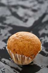 Tasty muffins arranged in pattern on light textured background, close-up, shallow depth of field, selective focus.