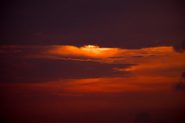 Morning red sky with sun hinding behind the cloud for nature background