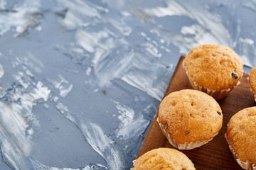 Top view close-up picture of tasty muffins on the cutting board, shallow depth of field, selective focus