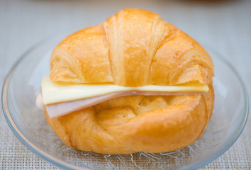 Ham and cheese sandwich croissant on glass dish