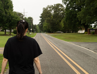 A woman walking down a road