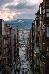 Fototapeta premium magical aerial view at sunset with reflections of the sun with the river and mountains in background in Bilbao. Spain