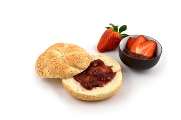 Bun with strawberry jam stock images. Strawberry with jam on a white background. Marmalade in a bowl. Breakfast still life. Pastry with marmalade