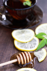 Fresh honey with a cup of black tea