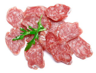 Dried sliced organic salami sausage on white background