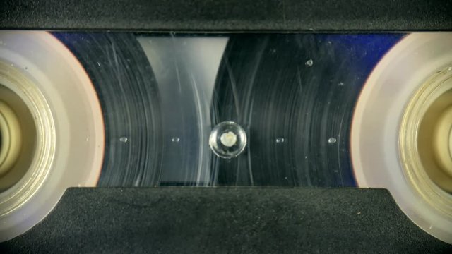 Old Audio cassette reel playing close-up. Fast rewind