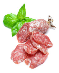 Dried sliced organic salami sausage on white background