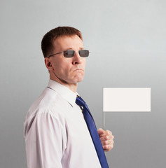 Serious solid man in a tie and glasses with a white flag in his hand. Character