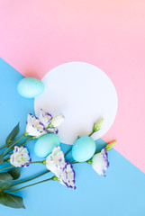 Easter eggs and spring flowers narcissi on blue background