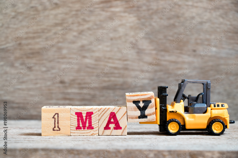 Sticker Toy forklift hold block Y to complete word 1may on wood background (Concept for calendar date 1 for month May)