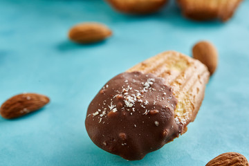 Yummy almond cookies arranged on blue background, close-up, selective focus, top view.