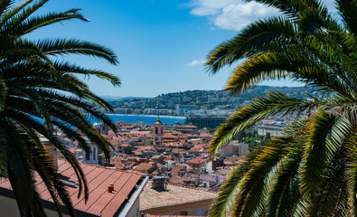 Fototapeta na wymiar View of the city of Nice in the south of France between two palm trees