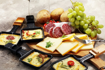 Delicious traditional Swiss melted raclette cheese on diced boiled or baked potato.