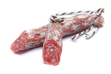 Dried organic salami sausage on white background