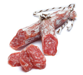 Dried organic salami sausage on white background