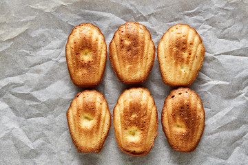 Sweet almond cookies put in rows on white paper background, close-up, selective focus