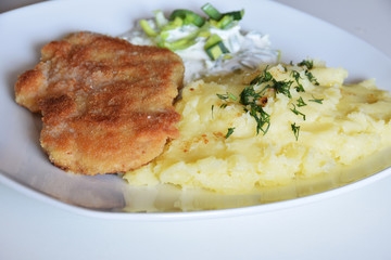 pork chop in bread crumbs, boiled potatoes with dill, leek salad with sour cream and mayonnaise,