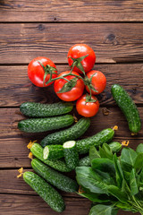 cucumbers and tomatoes on a wooden table