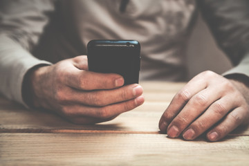 Man using phone in his desk.