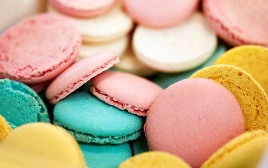 Fototapeta na wymiar cooking, confectionery and baking concept - close up of macarons