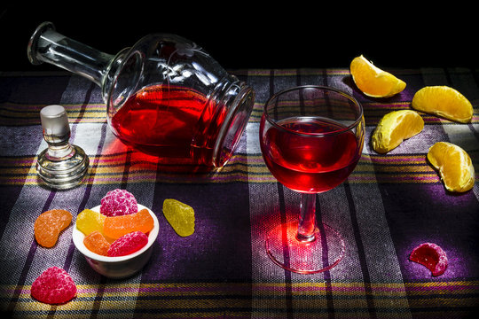 Still Life Decanter And A Glass Of Red Wine Snacks Candy And Orange.