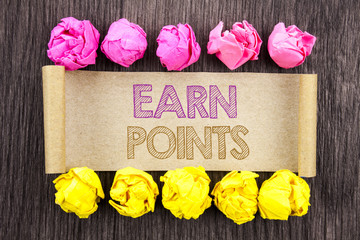 Writing text  Earn Points. Concept meaning Loyalty Reward Benefit Program For Earning Customer Point written on sticky note paper with folded paper yellow and pink on the wooden background.