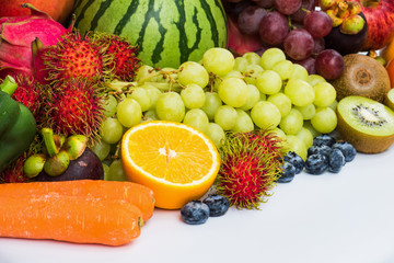 Closeup orange fruits slice with different fresh fruits and vegetables organic for eating healthy