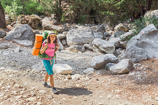 Traveler woman with a backpack walks along the mountain path by Lycian Trail in Turkey