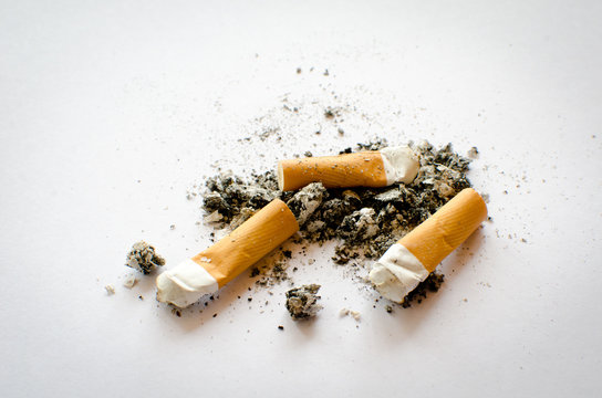 three cigarette butter and ash pile isolated on a white background, view from top,  copy space 