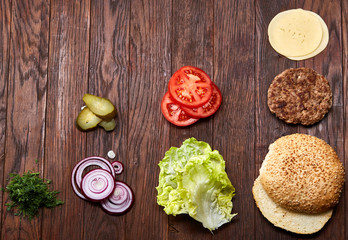 Fototapeta na wymiar Tasty hamburger ingredients are laid out separately from above, beautifully harmoniously, close-up, top view