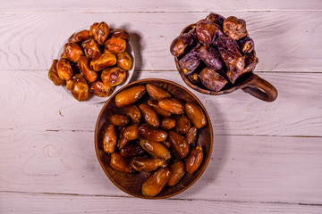 Date fruits on the white wooden table. Top view