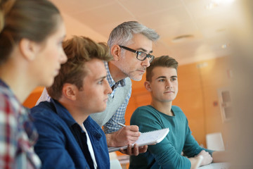 Teacher controlling students work in class