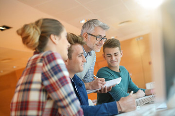 Teacher controlling students work in class