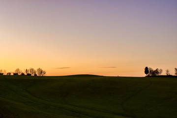 Fototapeta na wymiar Silhouette of a rural landscape at sunet
