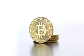 Golden Bitcoin facing the camera in sharp focus, close-up