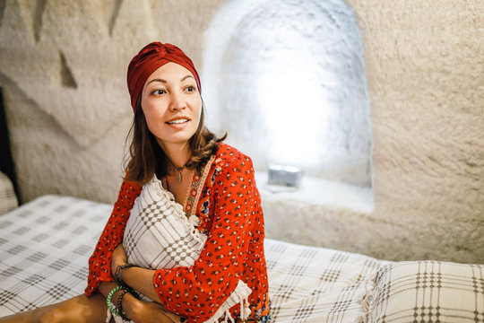 Woman relaxing in cave style hotel room in Cappadocia