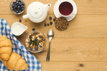 Continental breakfast with croissants and berries on natural woo