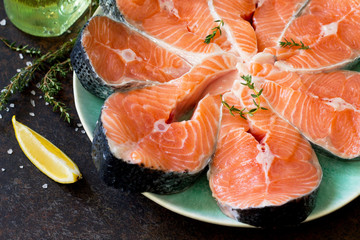 Fresh salmon on a dark stone table, preparation for cooking fish. Proper nutrition.