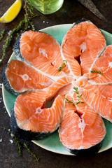 Fresh salmon on a dark stone table, preparation for cooking fish. Proper nutrition.