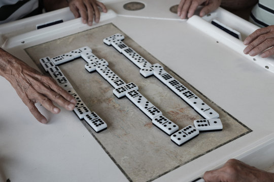 Men and woman of all ages play and compete against each other at one oc Cuba's favorite past time Dominoes