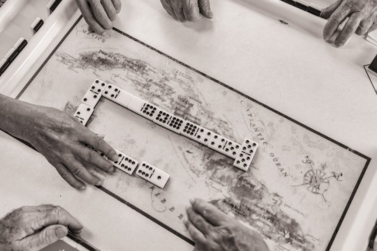 Men and woman of all ages play and compete against each other at one oc Cuba's favorite past time Dominoes
