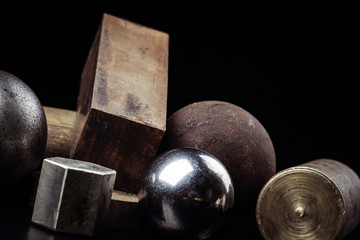 Metal details of different geometric shapes on a black background.