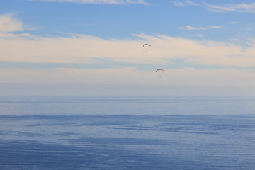 Fototapeta na wymiar Paragliding over the Ocean